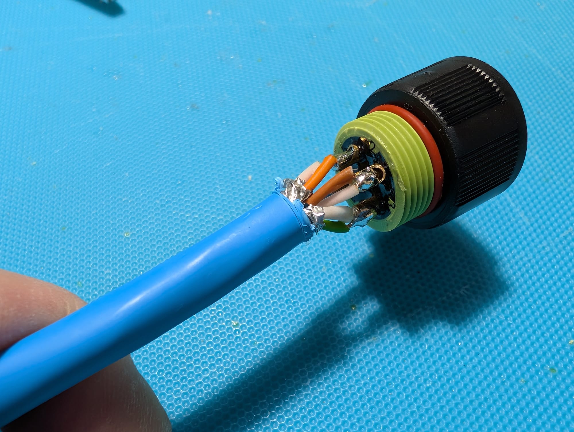 The open back of the Exceedconn connector with wires soldered to it.